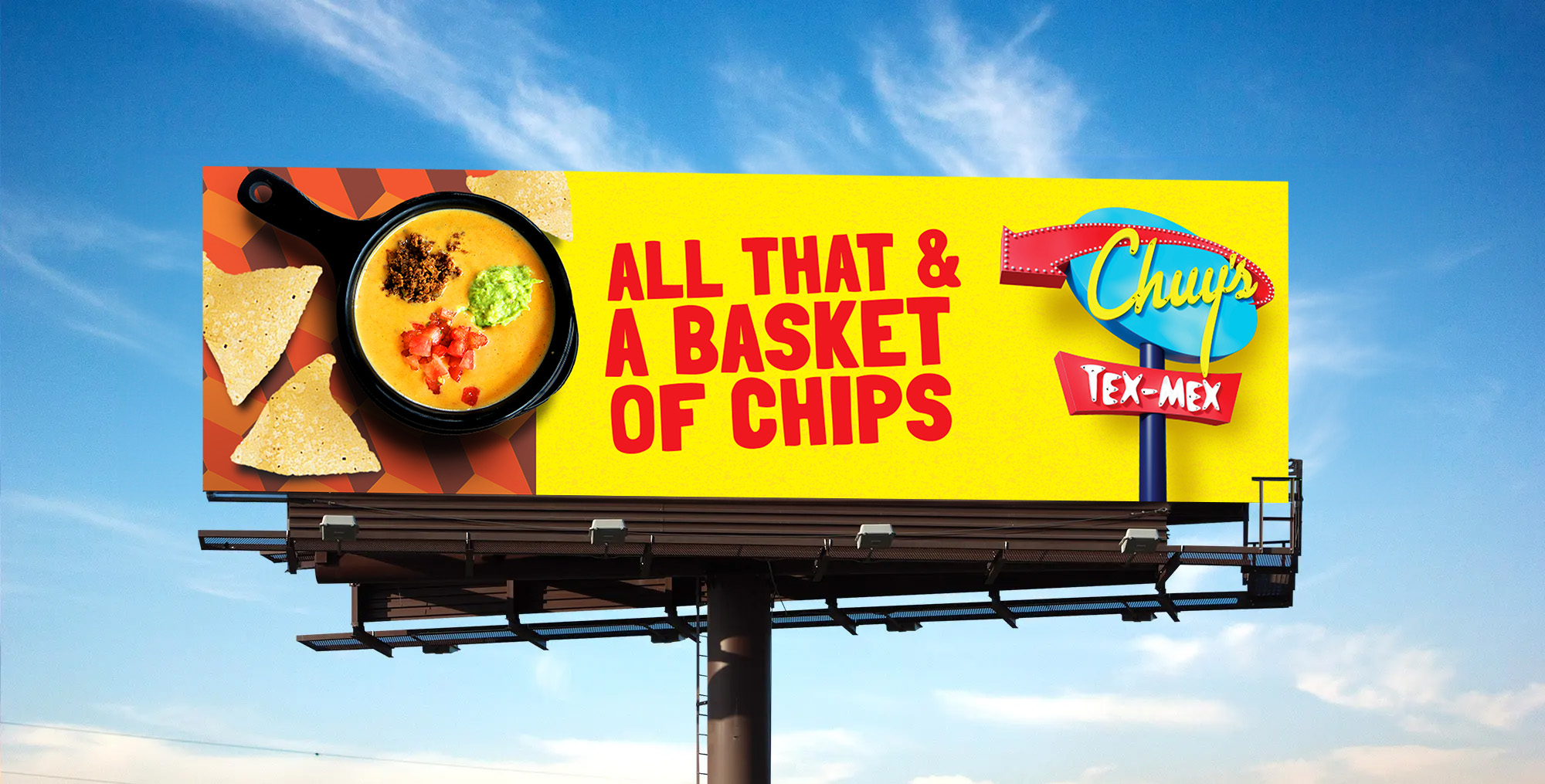 Chuy's billboard that reads "All that and a baskey of chips"